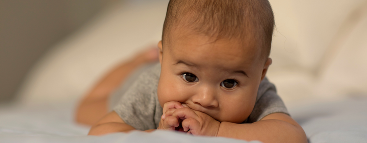 baby lying on bed