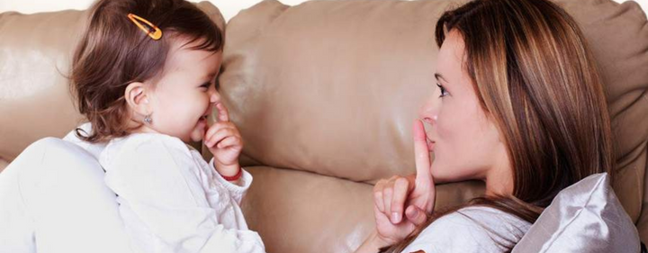 Mom communicating with baby through sign language